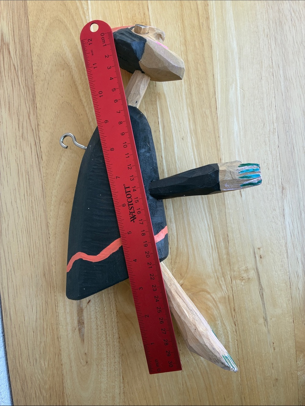 Strange hand carved folk art character with bland and orange clothes and a hook - Picture 13 of 13